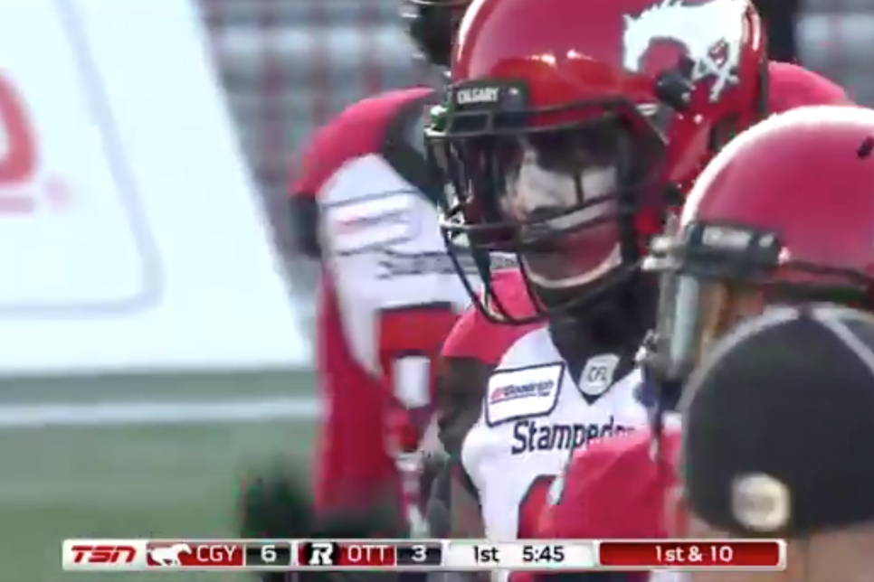 A CFL player in full Dark Knight Joker face paint intercepted a